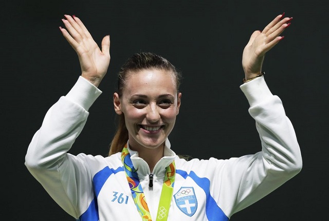 epa05461352 Anna Korakaki of Greece celebrates on the podium after winning the bronze medal in the women's 10m Air Pistol final of the Rio 2016 Olympic Games Shooting events at the Olympic Shooting Centre in Rio de Janeiro, Brazil, 07 August 2016. EPA/VALDRIN XHEMAJ